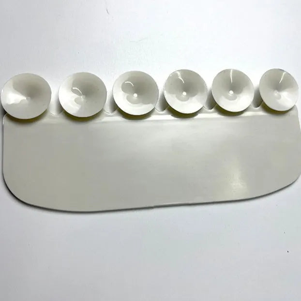 White PVC urine blocking splash guard for toilet training, shown on a toilet seat.