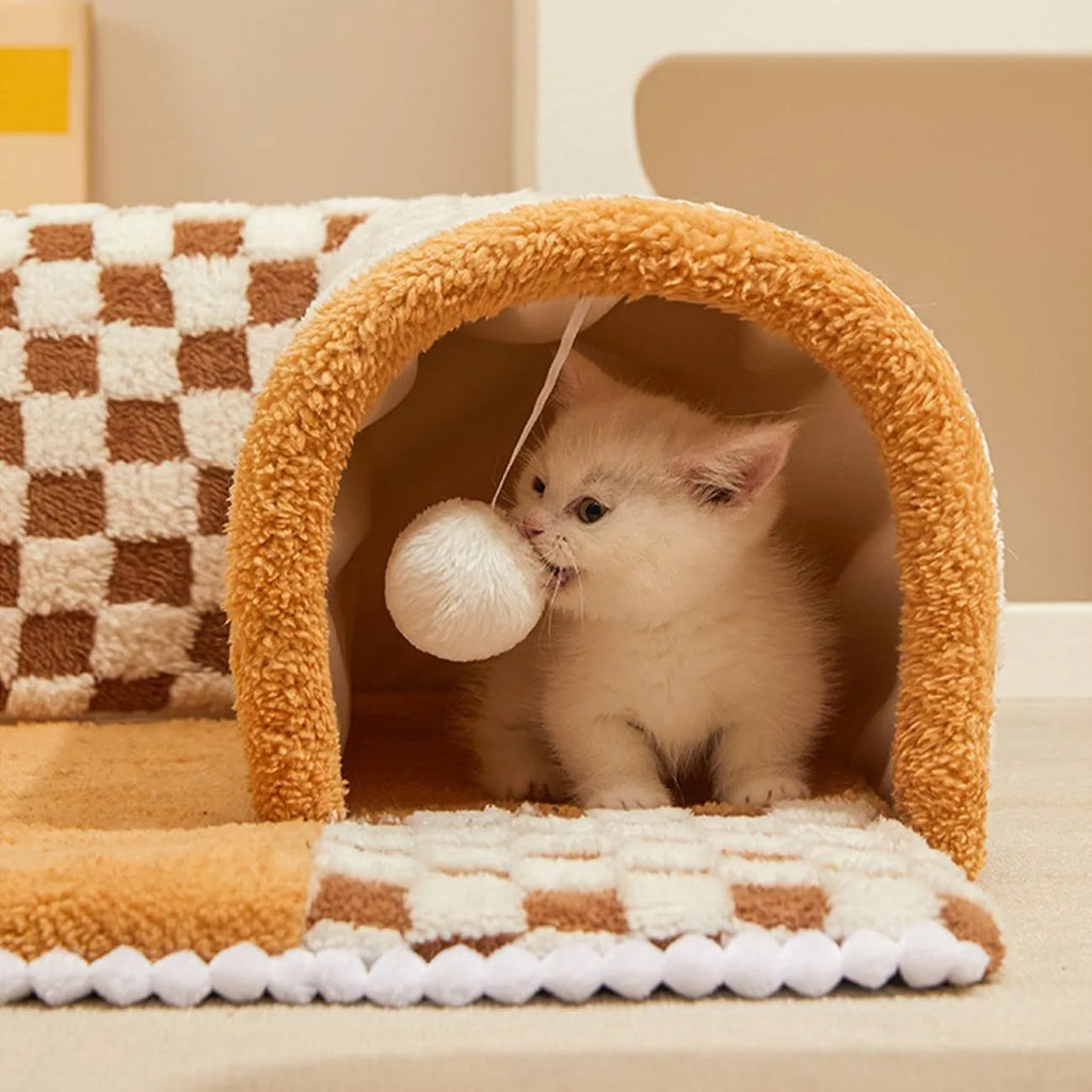 Large fan-shaped plush pet bed with attached tunnel in coffee colour on a wooden floor