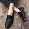 Men's black pointed slip-on business shoes with tassel detail on artificial PU upper