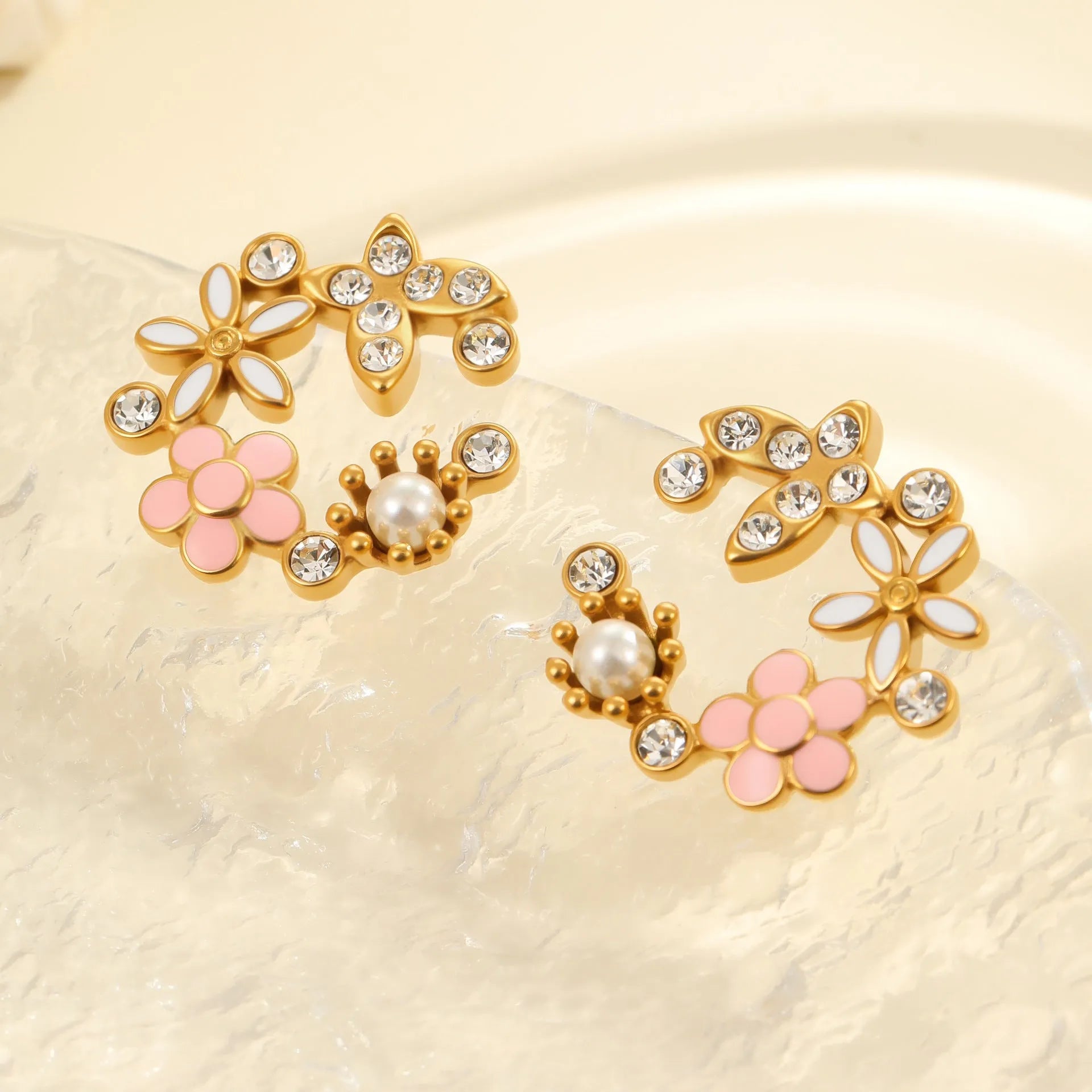 A pair of flower-shaped petal stud earrings with colourful oil finish and 18K electroplating on stainless steel.