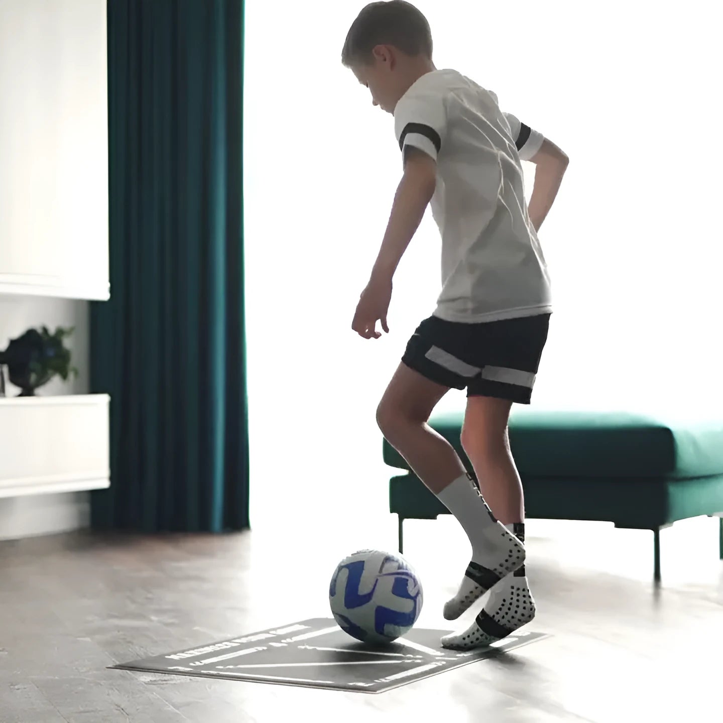 Black football training mat measuring 60 by 90 centimetres with non-slip base