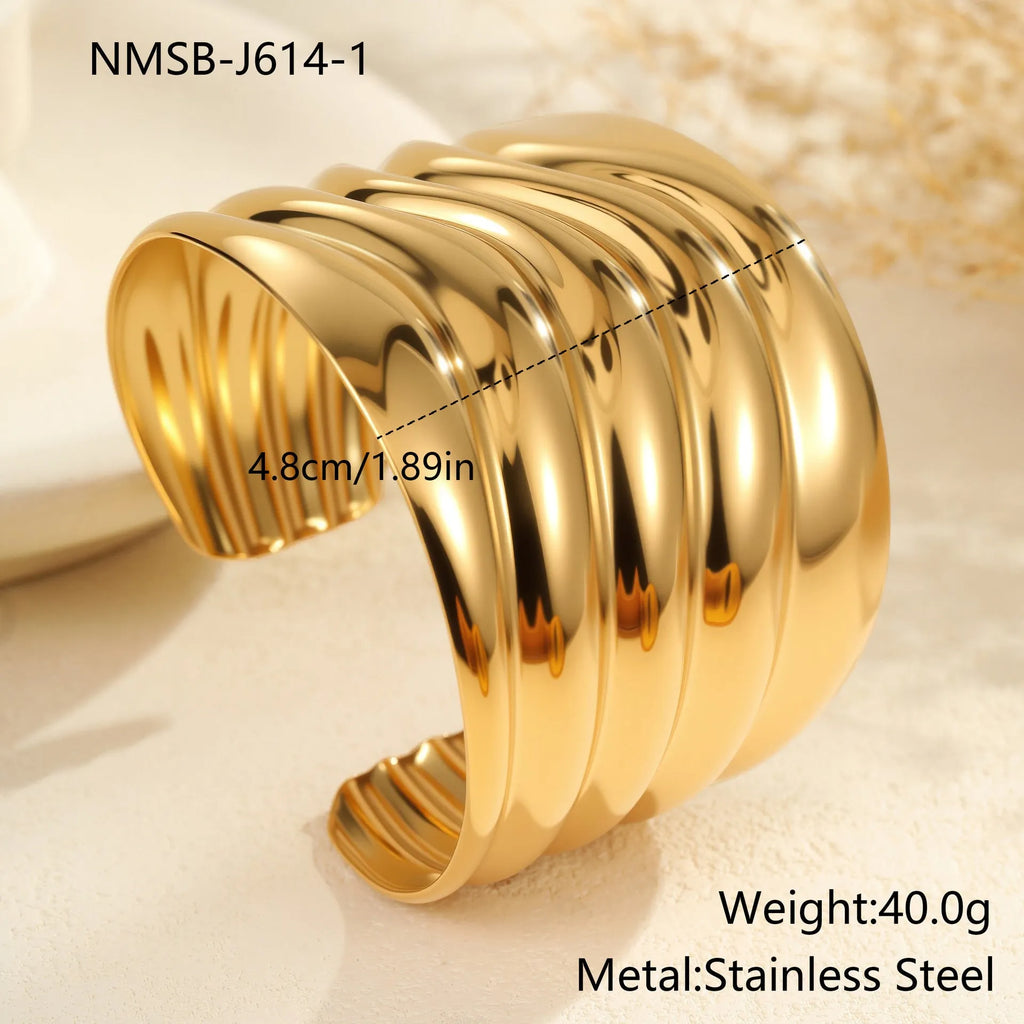 Women's fashion bracelet with exaggerated width, geometric wave patterns, and gold plating