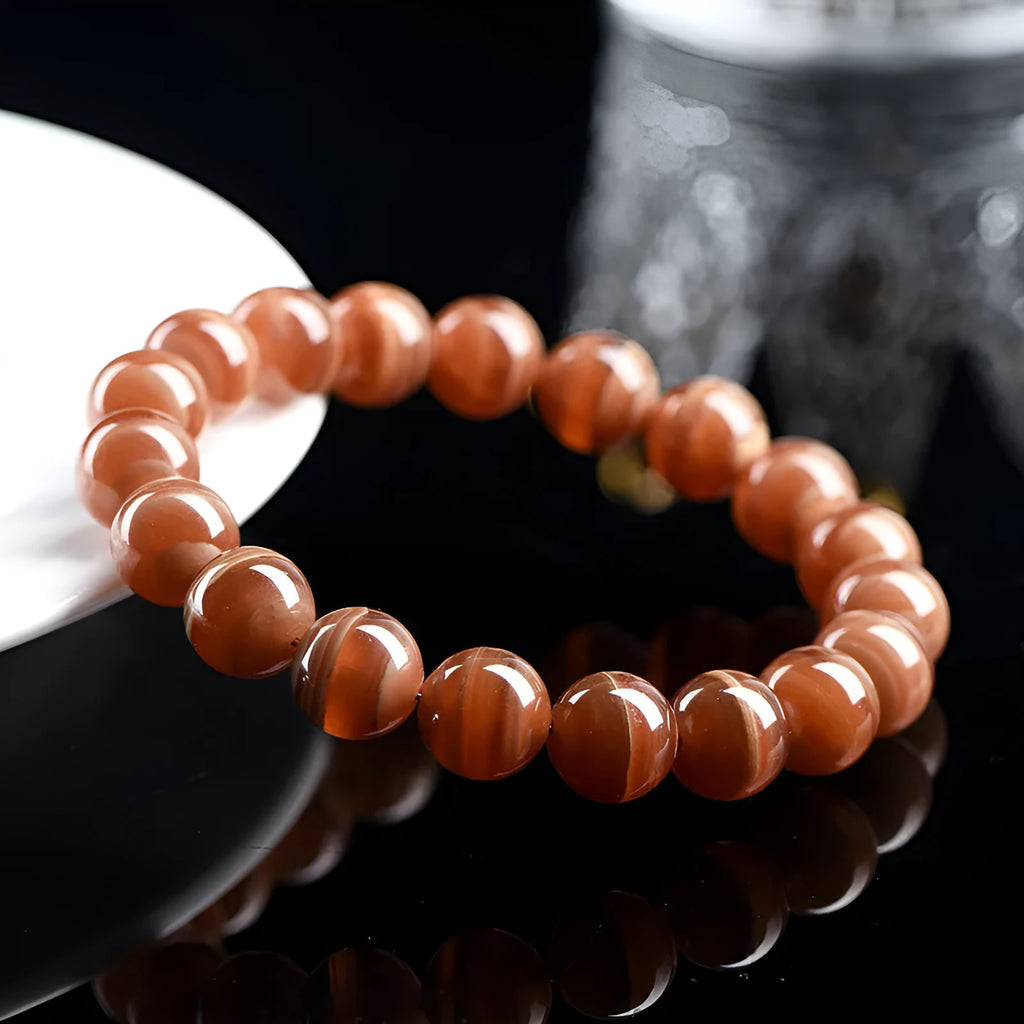 Natural old mine rhodochrosite round bead bracelet with ruyi design element.