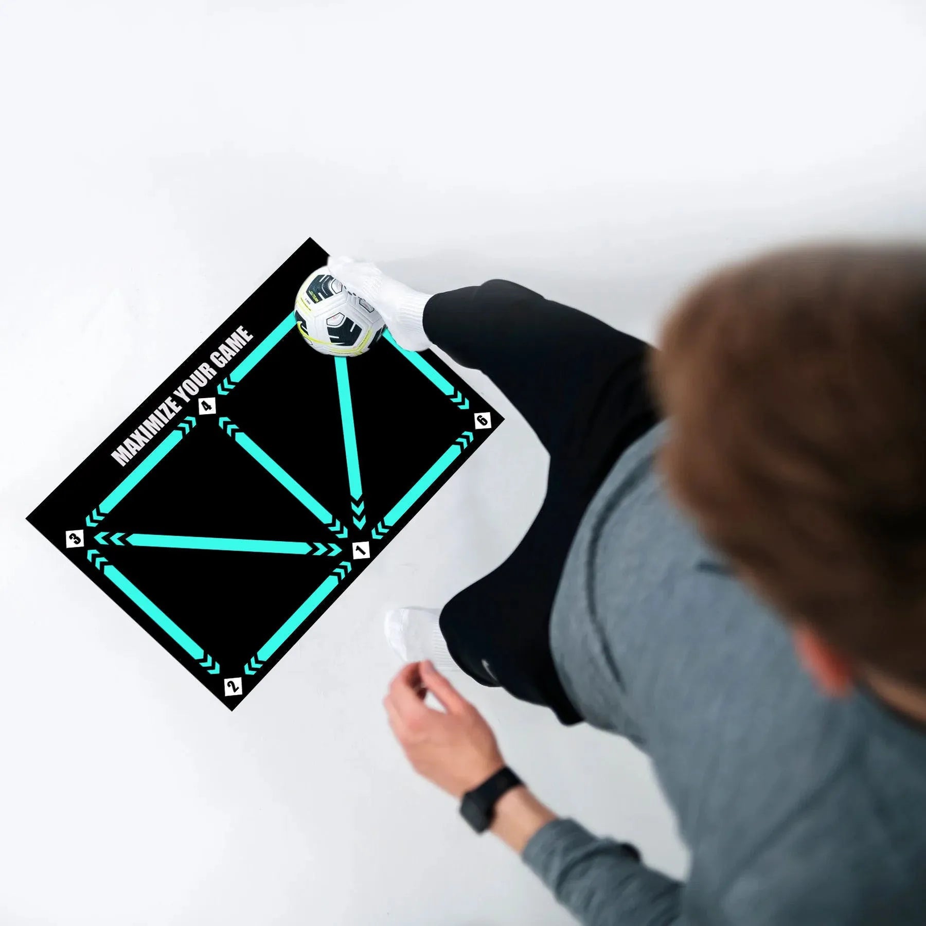 Black football training mat measuring 60 by 90 centimetres with non-slip base