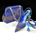 Women's pointed toe high heel shoes with rhinestone detail and a matching small bag.