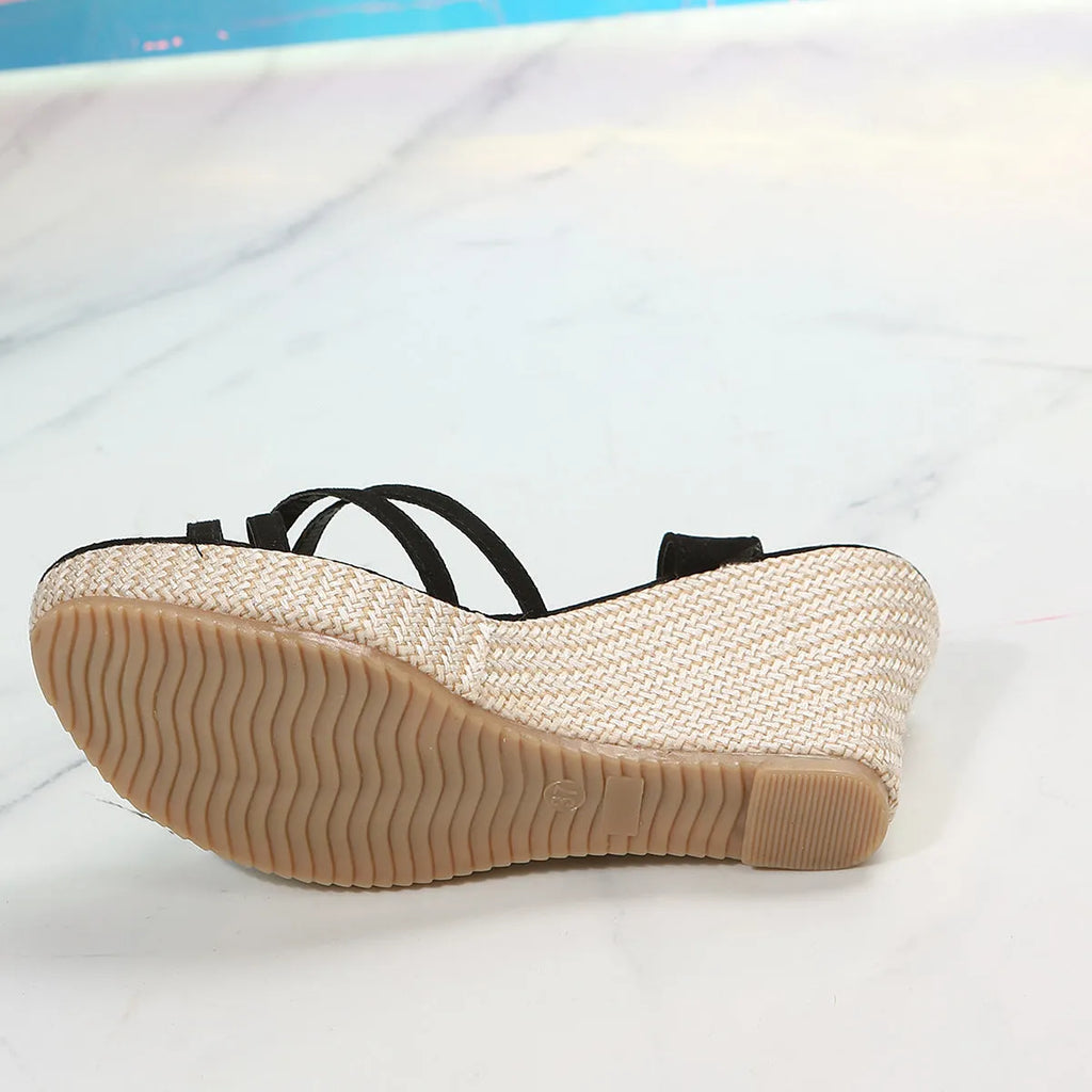 Women's black wedge sandals with fabric upper and fish mouth toe opening.