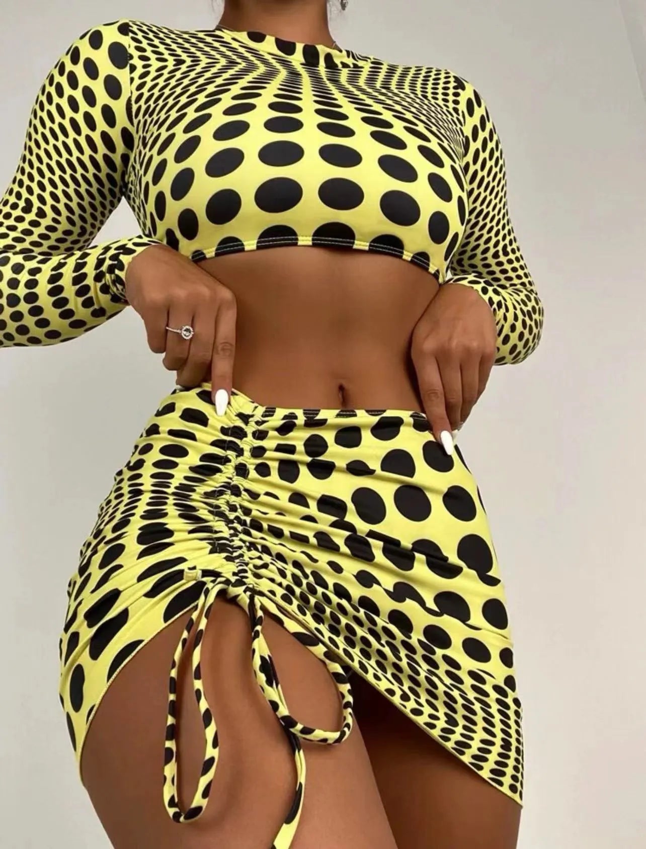 Women's green polka dot swimsuit three-piece set showing top, skirt, and bra components