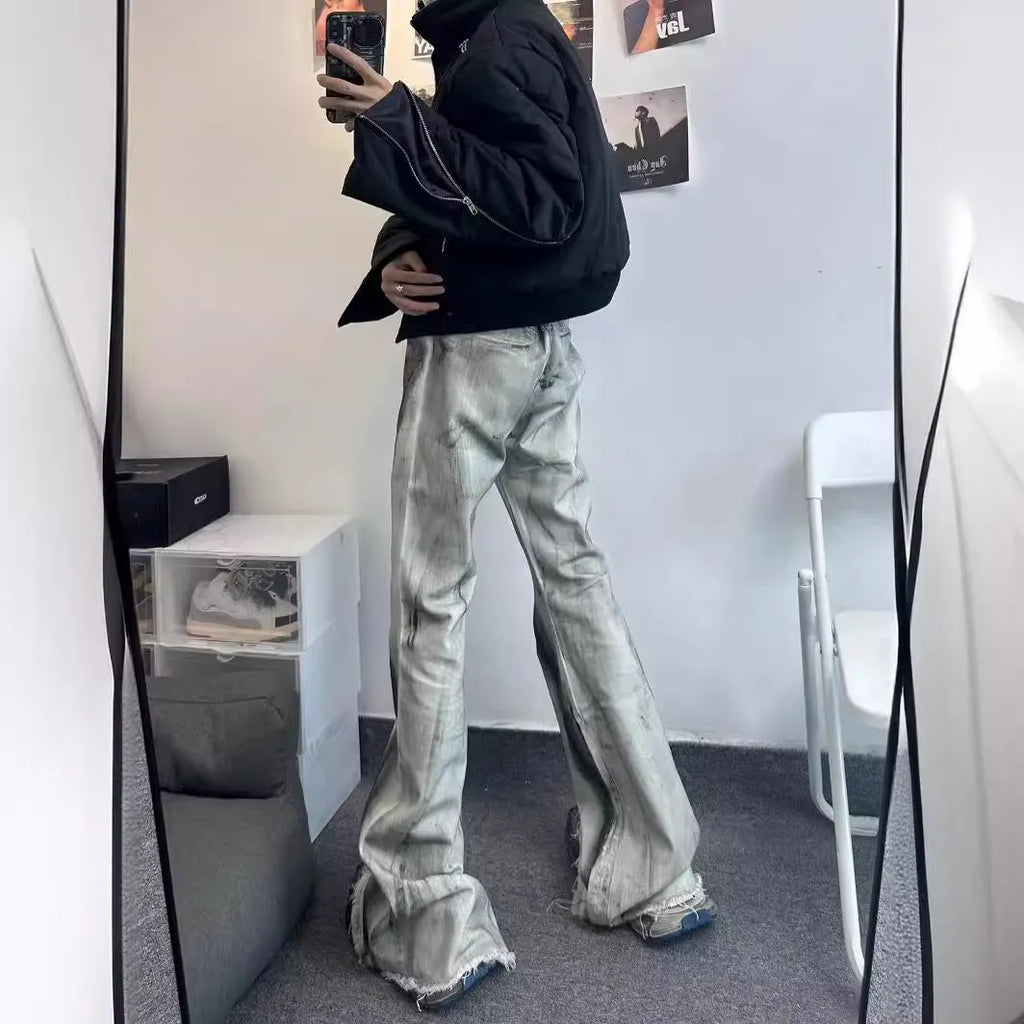 White denim jeans with a black ribbon gradient detail, showing a mid-waist fit and zip fly.