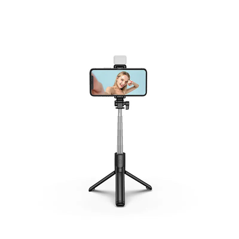 Black Bluetooth selfie stick with extended tripod legs and phone holder, shown with a smartphone attached.