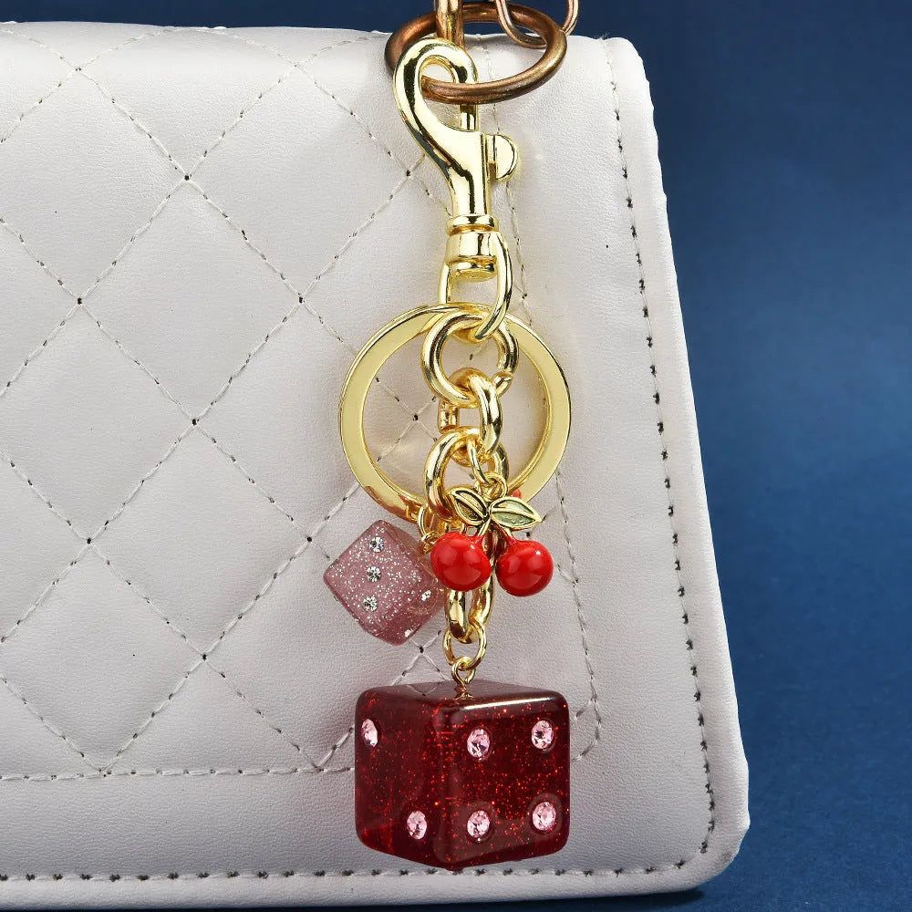 Square metal keychain pendant with a vintage cherry two-tone dice pattern for luggage or bags.