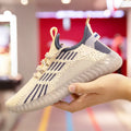 Men's white breathable flying fabric sports shoes with round toe and low-upper design.