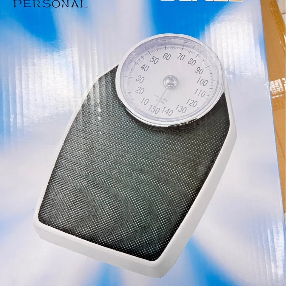 Black mechanical pointer body weight scale with large dial on a simple platform.
