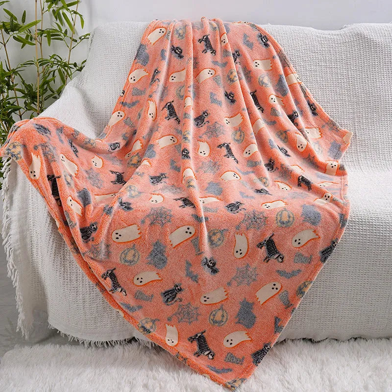 Cartoon print flannel blanket for children shown in two sizes on a bed.