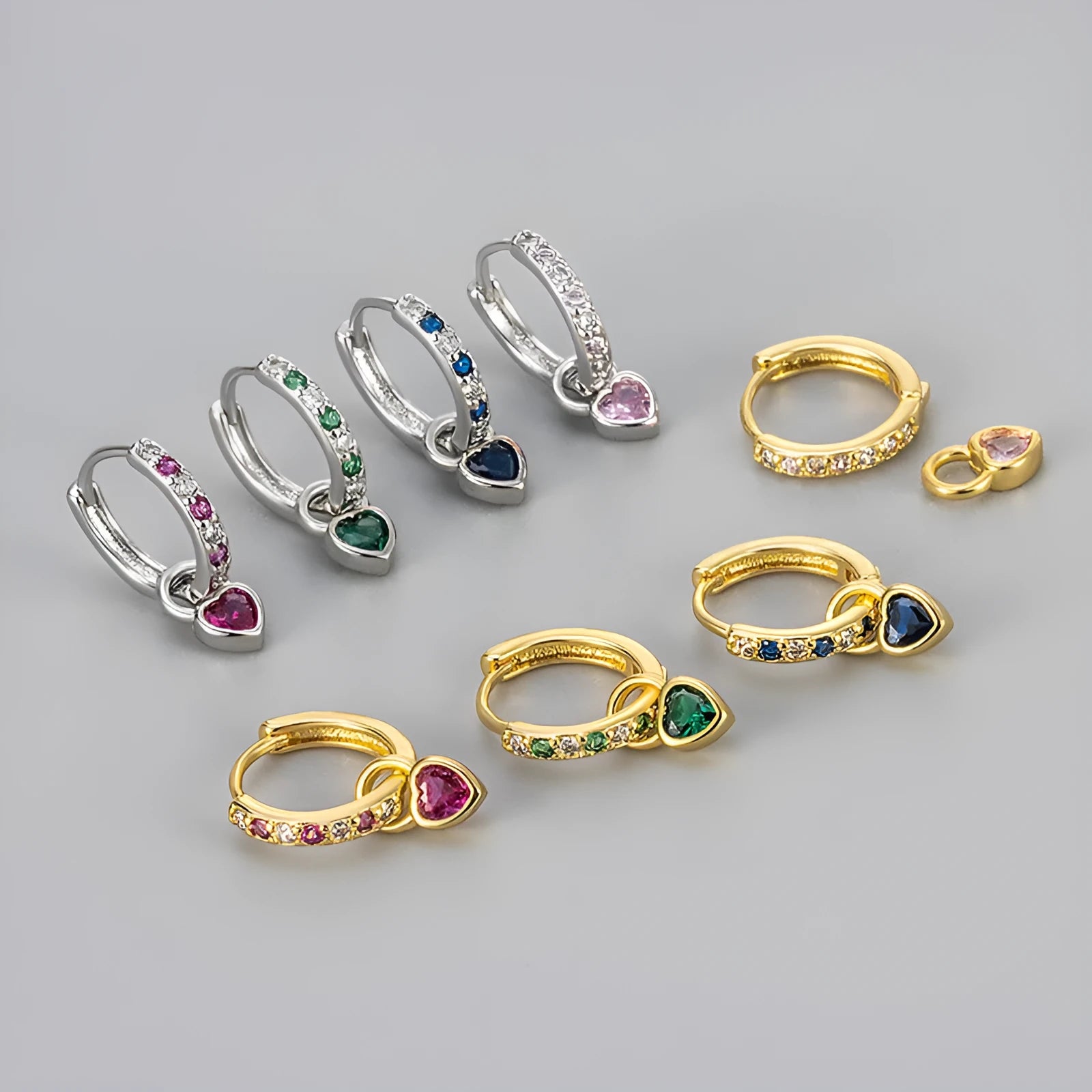 Women's gold tone earrings with a heart-shaped clip and a pink zircon drop pendant.