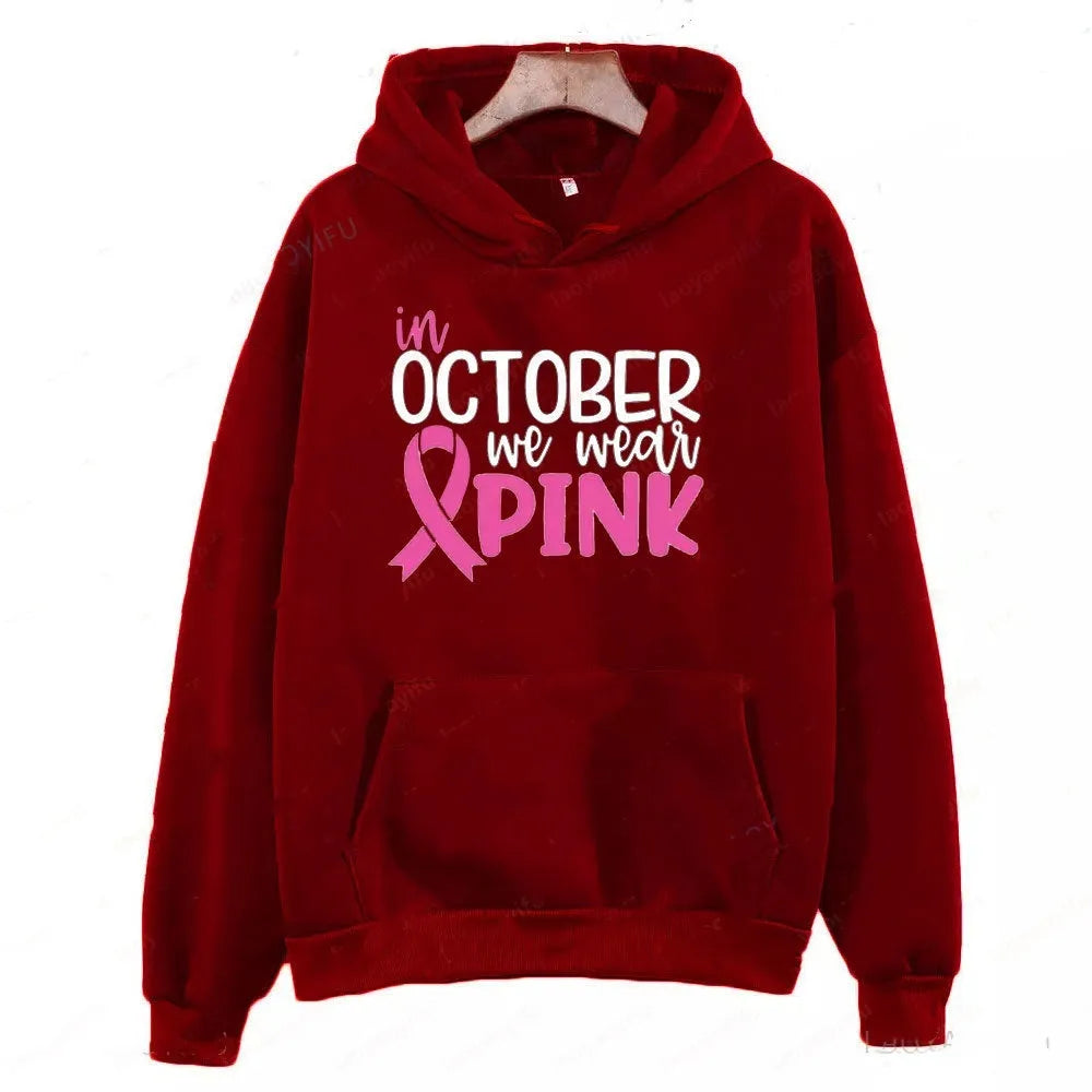 Women's pink graphic sweatshirt hoodie with 'I'm A Survivor' slogan and art retro pattern print.