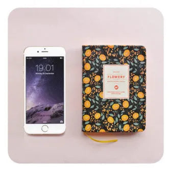Green floral pattern notepad with fabric leather cover showing wireless binding and open pages