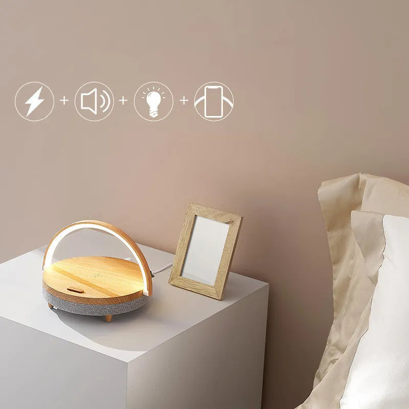 Wireless charging LED night light with Bluetooth speaker and integrated mobile phone holder in marble pattern finish