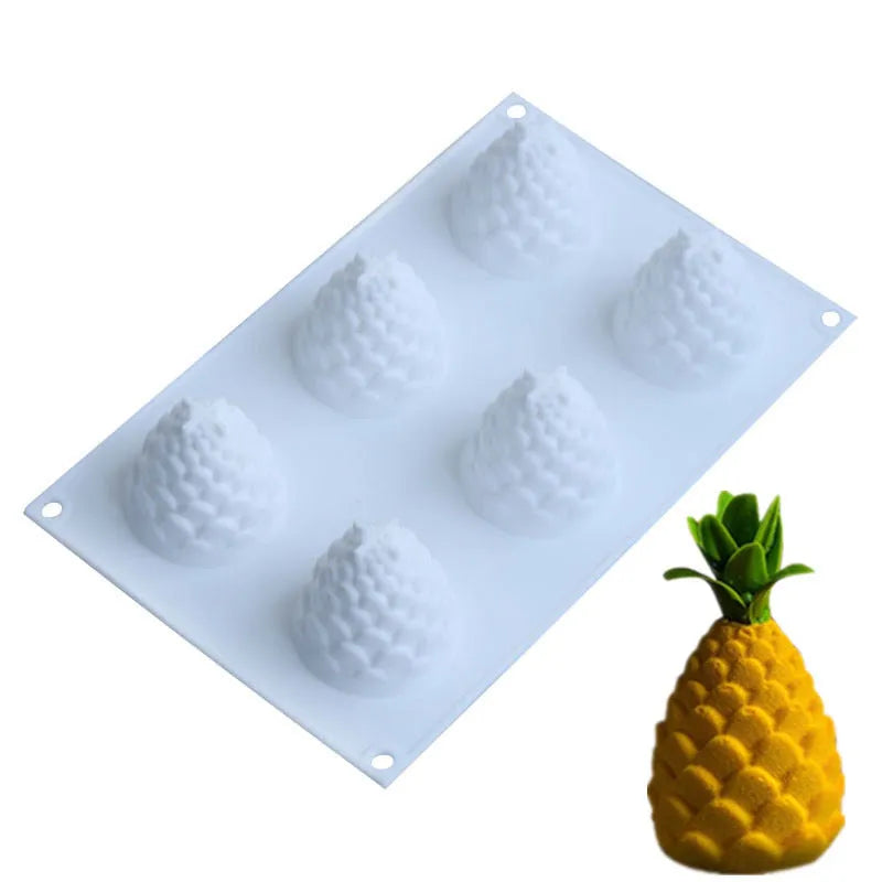 Silicone baking mould with six detailed pineapple and pine cone shaped cavities.