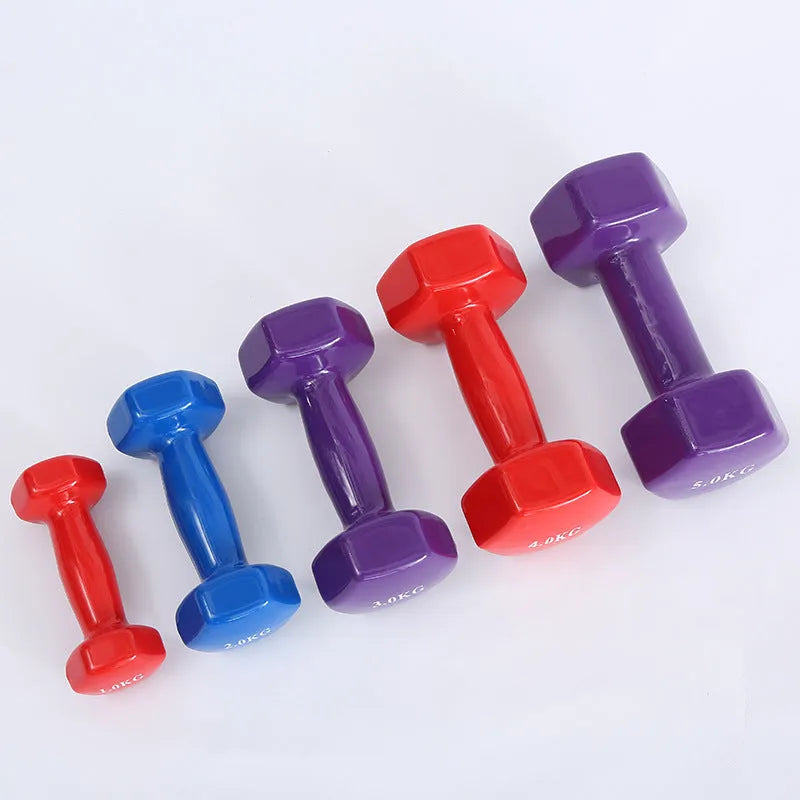Bright colour plastic fitness dumbbells in random colours showing glossy surface finish for home exercise