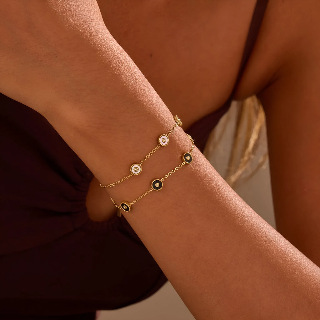 Women's stainless steel bracelet and necklace set with 18K gold plating and geometric design.