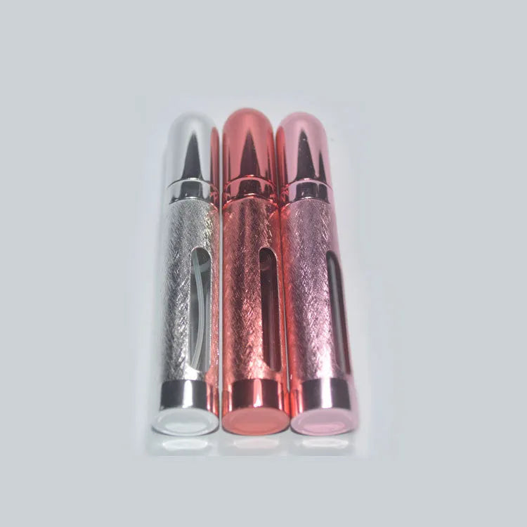 Slender aluminium travel perfume bottle with glass liner in a choice of six colours, shown next to a ruler showing 115mm length.