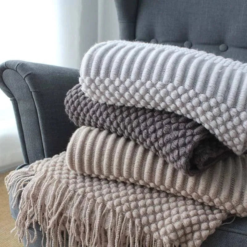 Small grey polyester nap blanket laid flat showing its size.