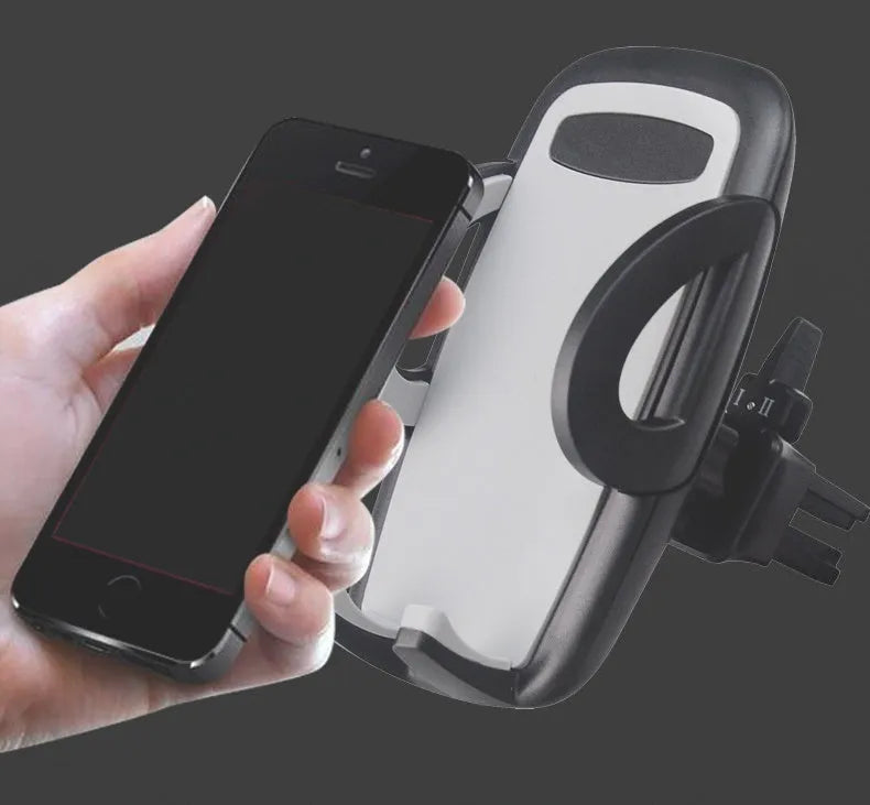 Black plastic mobile phone holder mounted on a car air conditioning vent
