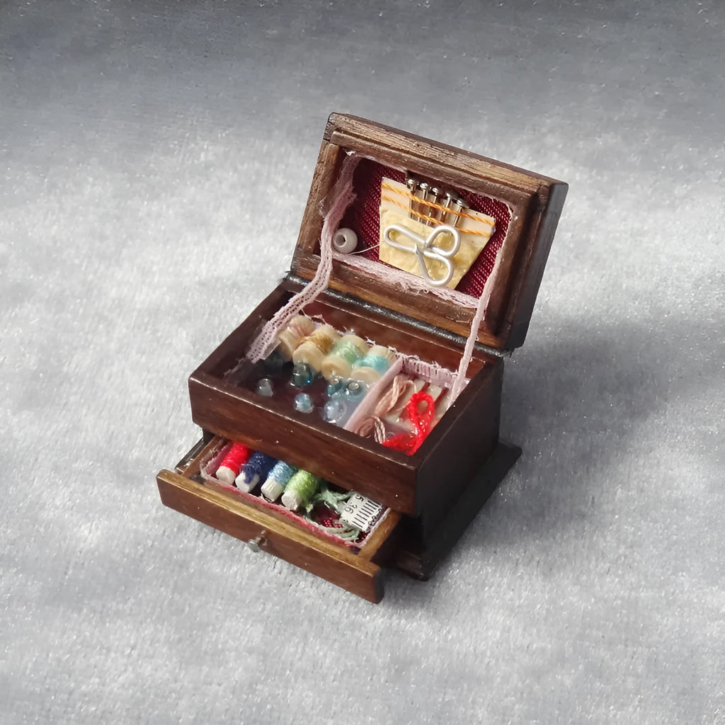 Small vintage sewing machine miniature ornament in a birch wood box with accessories.