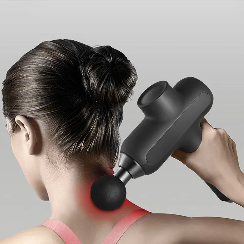 Black electric muscle massager with six removable heads showing five-speed control button