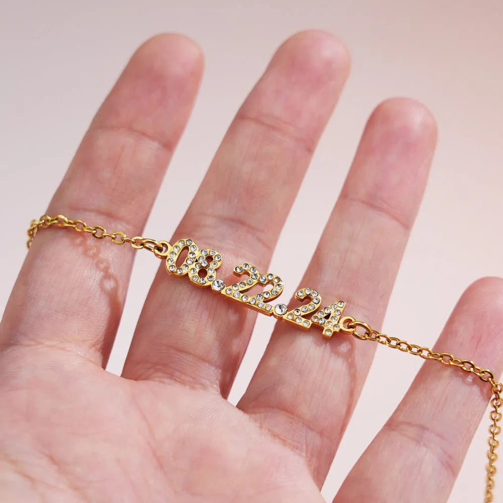 Stainless steel digital bracelet with diamond-studded numbers on the face, shown in a rose gold finish.