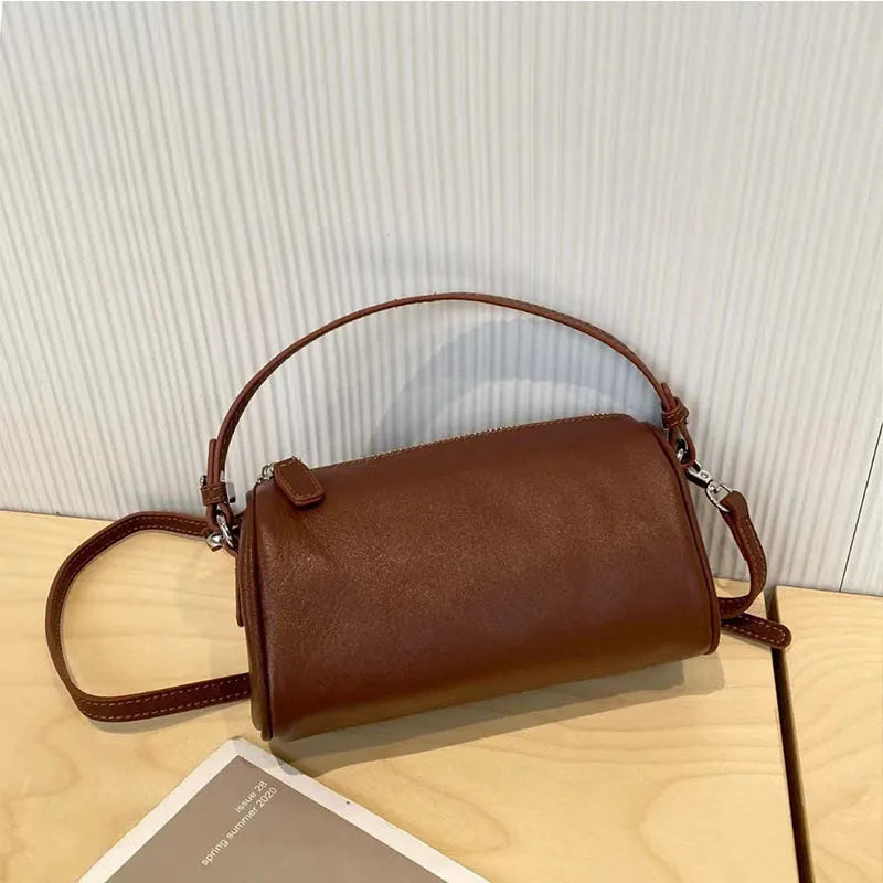 Cylindrical leather crossbody phone bag in vegetable tanned genuine leather with sewing thread detailing