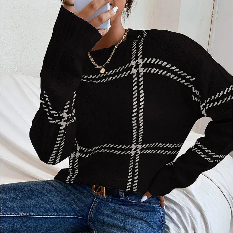 Women's loose-fit plaid sweater with apricot, black, beige, red, and green colour-block stripes.