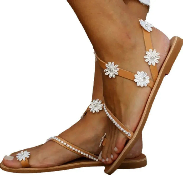 Brown ladies Roman sandals with flower pattern and flat rubber sole