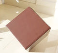 Square corrugated cardboard packaging box in black, brown, grey, and white colour options on a white background.