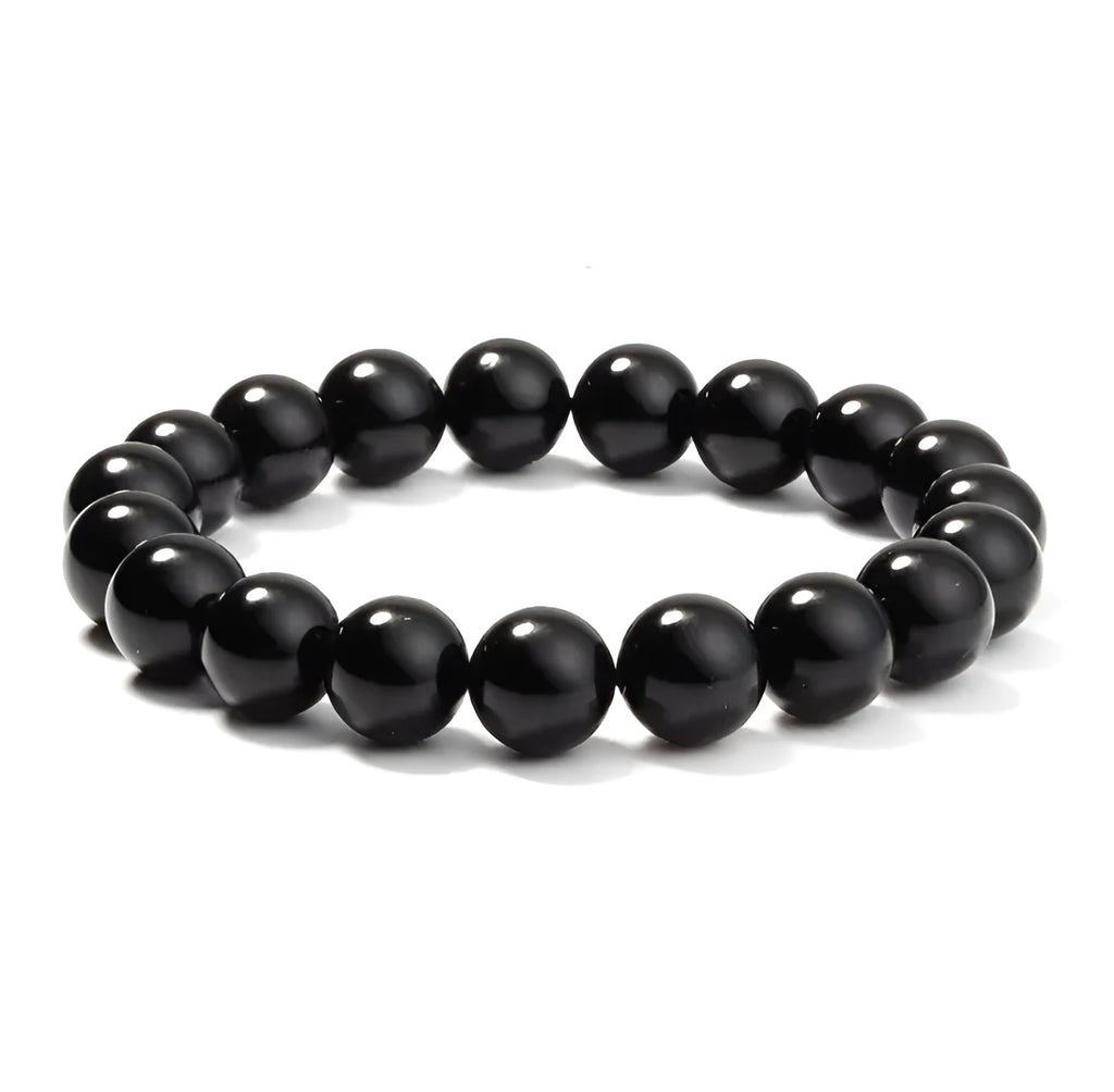 Black agate bracelet with geometric 8mm beads on a black elastic cord, laid flat.