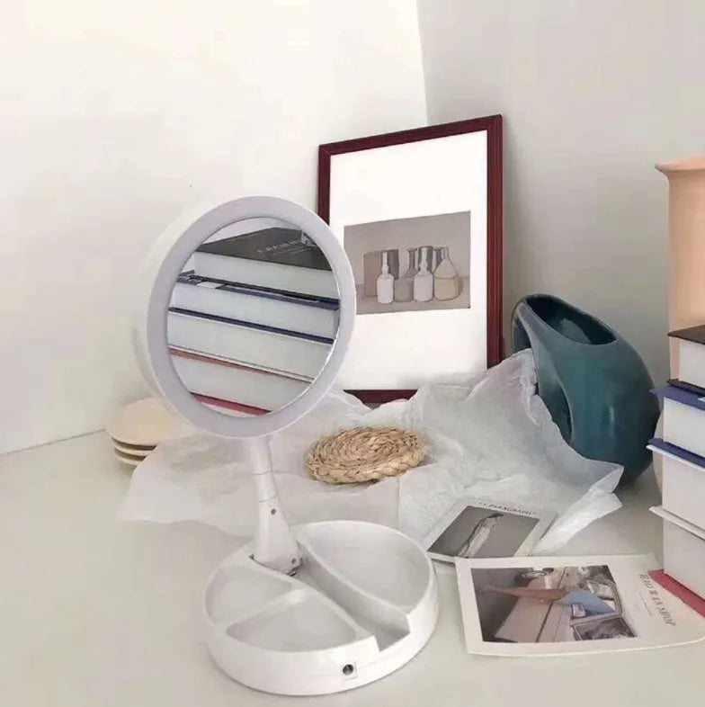 White foldable LED vanity mirror showing 1x and 5x magnification sides and USB charging port.