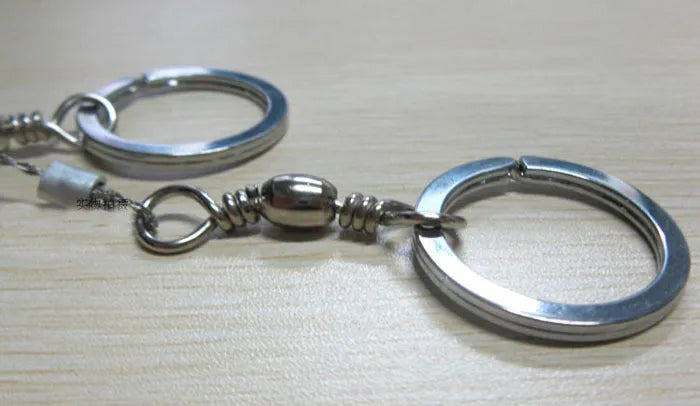Stainless steel survival wire saw with thumb rings, extended to show its 70cm length.