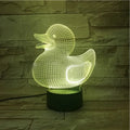 Little yellow duck 3D night light showing seven colour options and remote control on a desk