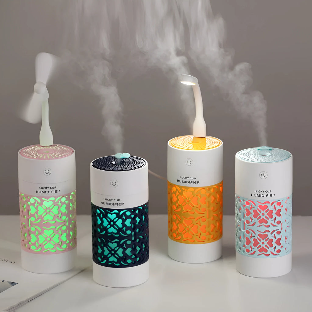 Lucky desktop humidifier 250ml USB powered in black with blue water bottle showing mist output on office desk