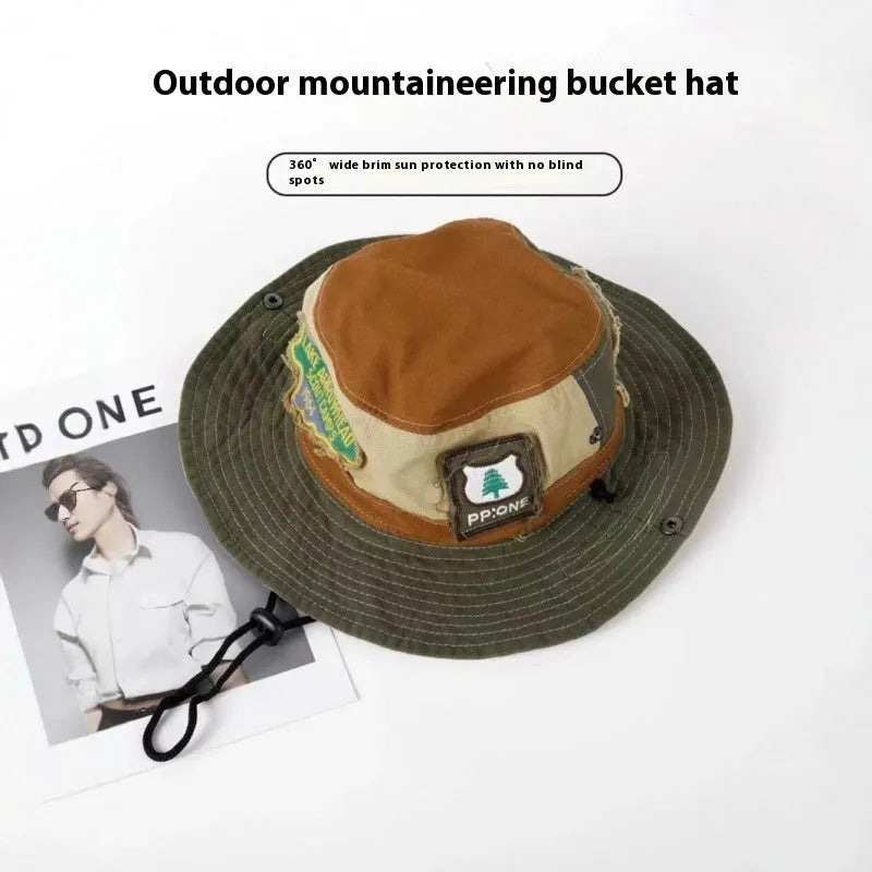 Army green cotton fisherman hat with flat crown and patchwork design folded for storage