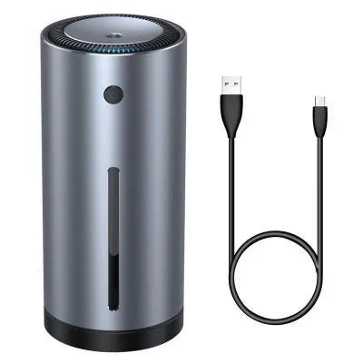Black aluminium alloy car diffuser humidifier with USB cable on a desk.