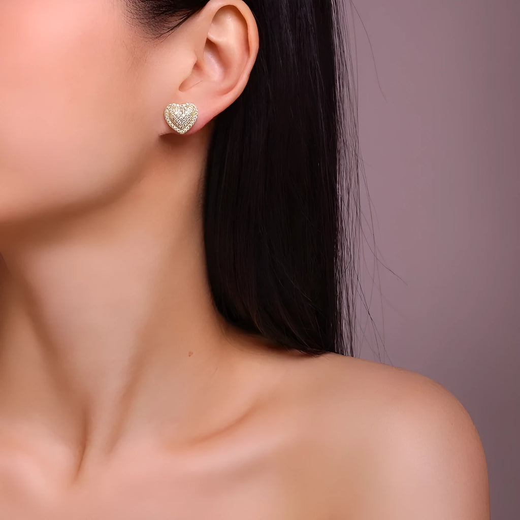 Simple heart-shaped stud earrings made of S925 silver with moissanite, shown in a gold colour.