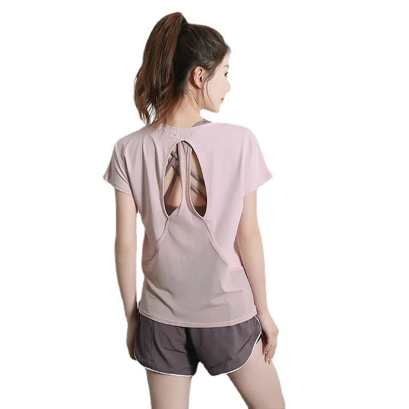 Women's pink polyester short sleeve sports T-shirt for running and fitness.