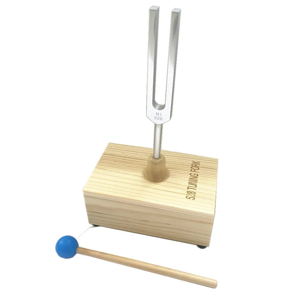 Aluminium alloy 432Hz tuning fork with connected speaker on kraft paper box