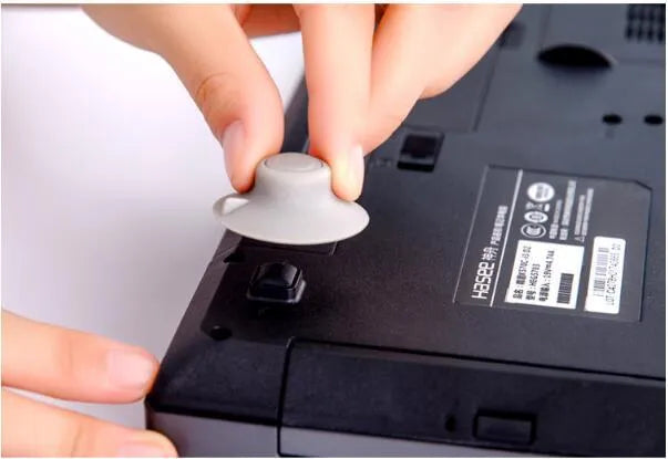 Set of four grey non-slip plastic cooling pads for laptops, shown in two different sizes.