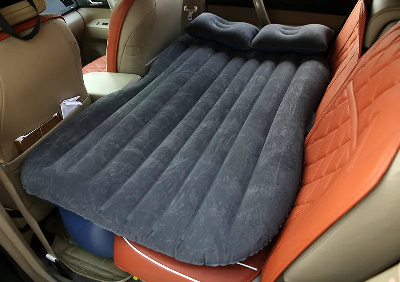 Universal inflatable car bed with flocking material, shown with pump, pillows, and storage bag.