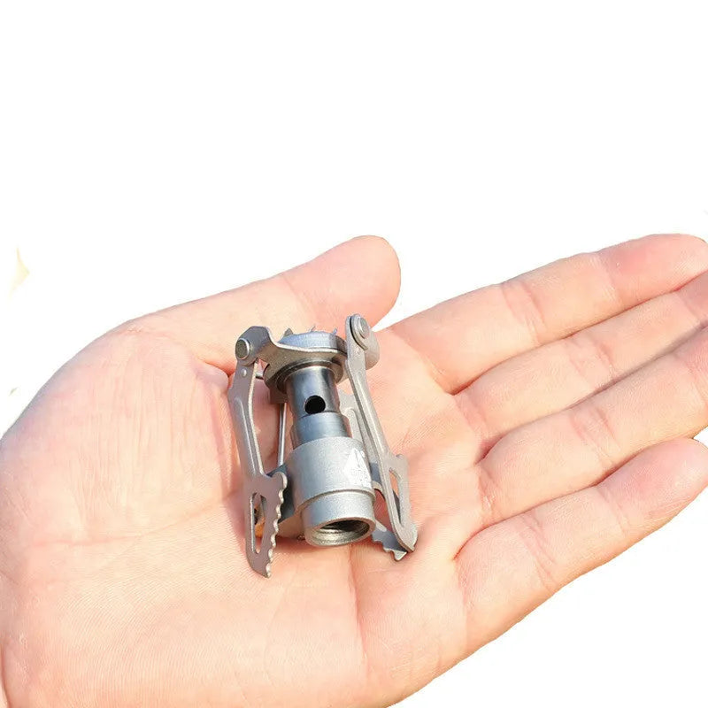Portable one-piece propane gas camping stove for outdoor use.