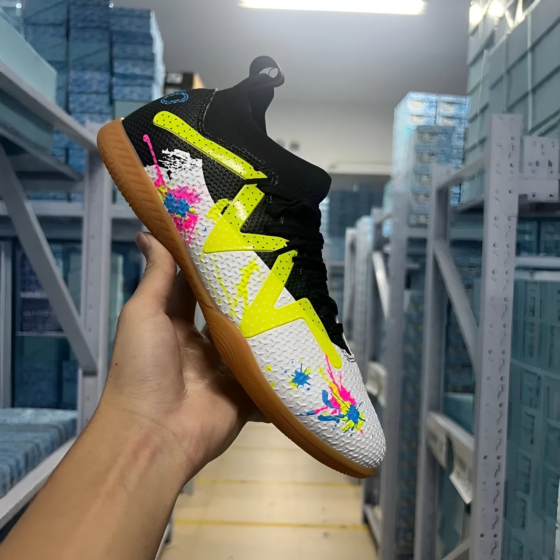 Low-top adult football boots with replaceable studs in Black & Yellow, White Black, and White Powder colour options.