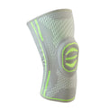 A pair of cotton mountaineering knee pads in blue, shown on a knee.