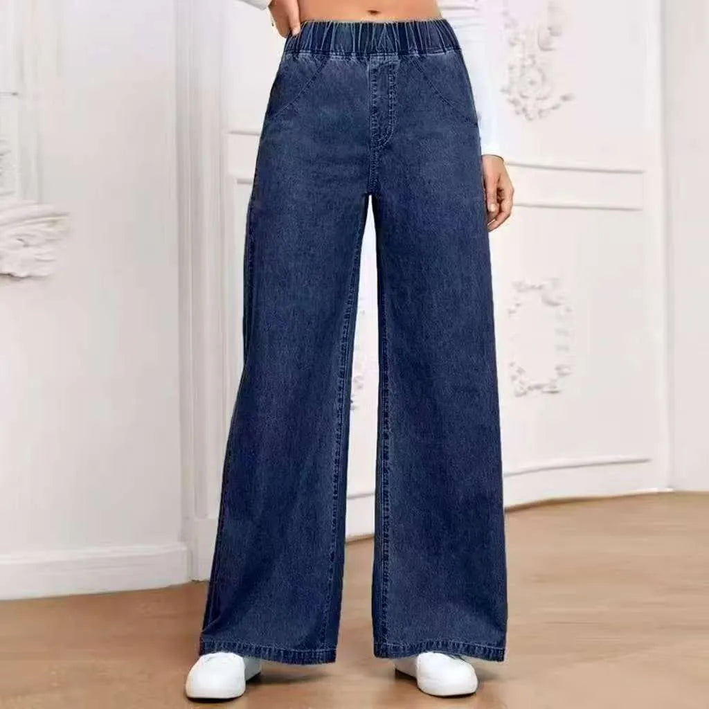 Light blue washed wide-leg denim trousers on hanger showing straight fit and mid-rise waist